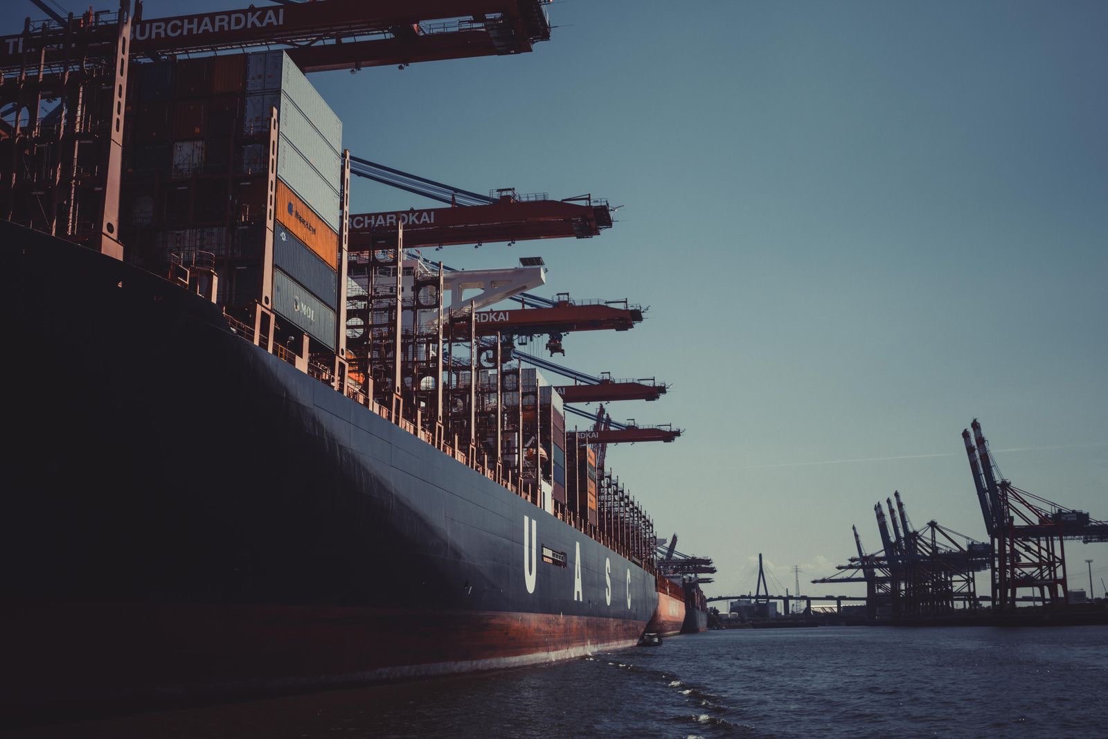 Container ship at a Seattle–Tacoma terminal at dusk