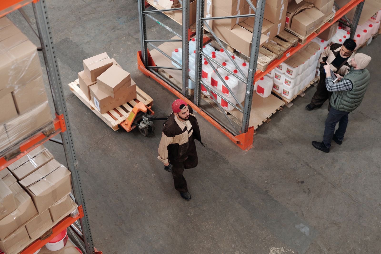 Warehouse crew moving parcels and pallets
